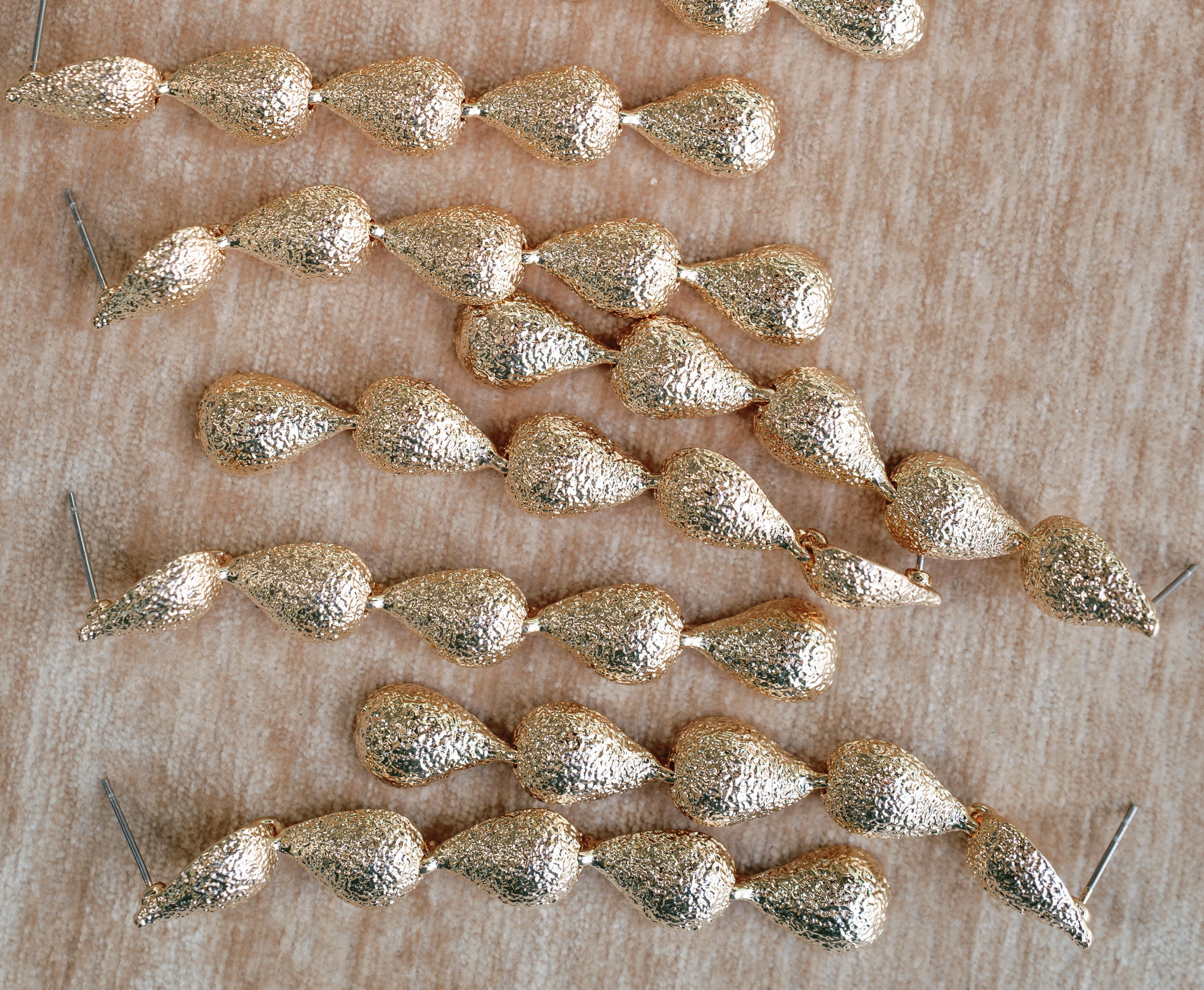 Swingy Textured Gold Teardrop Cascade Statement Earrings